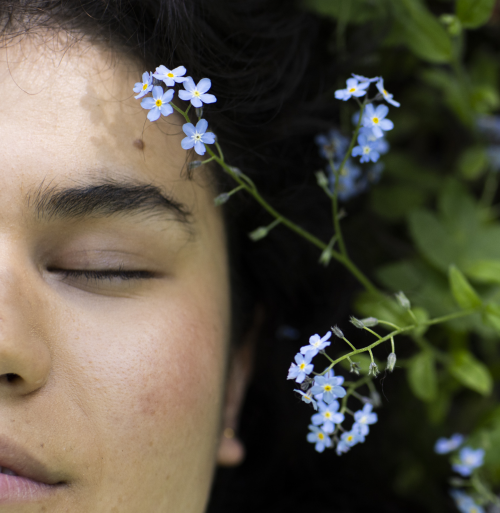 Woman lying eyes closed in wildflowers